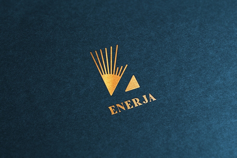 May include: A gold logo on a dark blue background. The logo features a stylized sun with rays and a triangle. The word "ENERJA" is written below the logo.