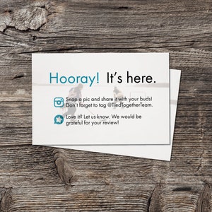 May include: A white card with blue text that reads "Hooray! It's here."  The card also includes a camera icon with the text "Snap a pic and share it with your buds! Don't forget to tag @TiedTogetherTeam." and a star icon with the text "Love it? Let us know. We would be grateful for your review!"