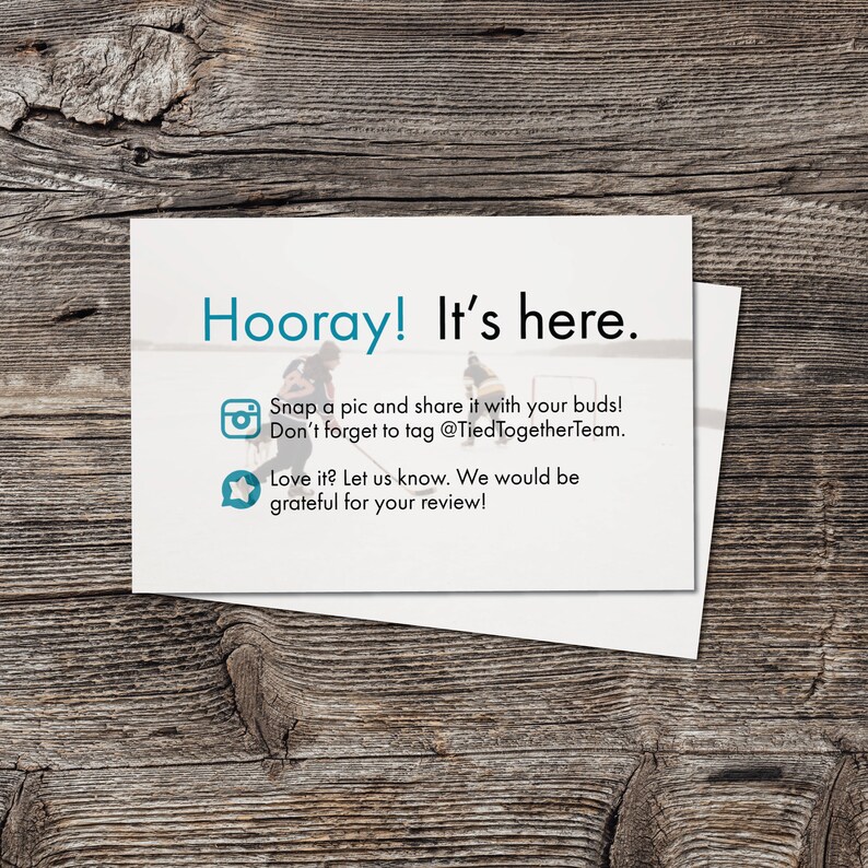 May include: A white card with blue text that reads "Hooray! It's here."  The card also includes a camera icon with the text "Snap a pic and share it with your buds! Don't forget to tag @TiedTogetherTeam." and a star icon with the text "Love it? Let us know. We would be grateful for your review!"