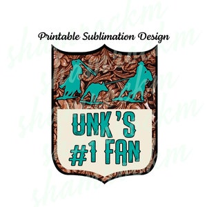 May include: A brown leather-textured shield with a turquoise border. The shield has a turquoise design of two cowboys roping a calf. The text "UNK'S #1 FAN" is in turquoise letters on a cream background.