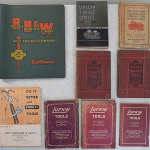 May include: A collection of vintage tool catalogs, including catalogs for Russell Burdsall & Ward Bolt and Nut Company, Union Twist Drill Co., Starrett Tools, Stanley Tools, and Lufkin Tools. The catalogs are in various colors, including green, red, and black.