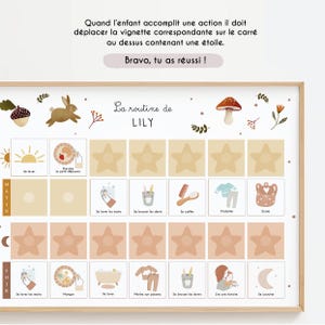 May include: A framed daily routine chart for a child, featuring illustrations and text in French. The chart includes sections for morning and evening activities, with star-shaped spaces for visual tracking. The text reads "La routine de LILY".