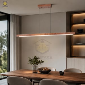 May include: A modern wooden linear pendant light fixture with a bright white LED light. The fixture is suspended by thin black wires above a wooden dining table. The light is approximately 48 inches long.