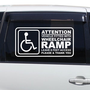 May include: White decal with a wheelchair symbol and the text "ATTENTION VEHICLE FITTED WITH WHEELCHAIR RAMP LEAVE 8 FEET ACCESS PLEASE & THANK YOU" on a white car.
