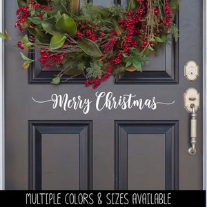 May include: White vinyl decal with the text "Merry Christmas" on a gray front door with a red and green Christmas wreath.
