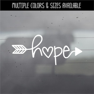 May include: A white vinyl decal featuring the word hope in a cursive script, where the letter o is replaced by a heart shape and the word is integrated into an arrow design. The text MULTIPLE COLORS & SIZES AVAILABLE appears at the top.
