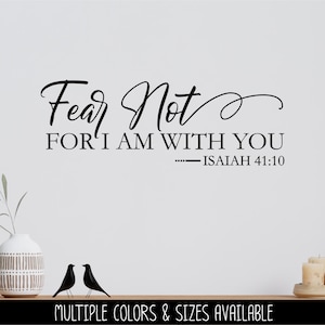 May include: Black and white wall decal with the text "Fear Not FOR I AM WITH YOU - ISAIAH 41:10". The decal is on a white wall with a vase and two birds on a shelf below.