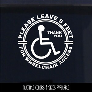 May include: A white circular vinyl decal featuring a central wheelchair accessibility icon. The text reads PLEASE LEAVE 8 FEET FOR WHEELCHAIR ACCESS and THANK YOU. The design is presented as a clean graphic on a dark background for high contrast visibility.