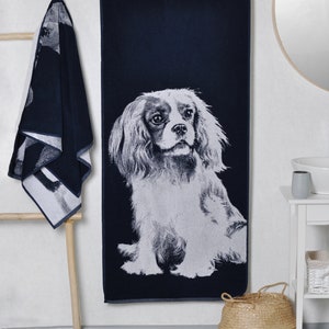 Peut inclure: Une serviette de bain bleu marine avec une image blanche d'un chien Cavalier King Charles Spaniel.