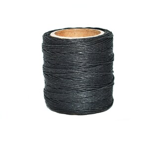 May include: A spool of black waxed thread for leather crafting.