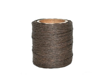 May include: A spool of brown waxed thread, wound tightly on a cardboard tube.