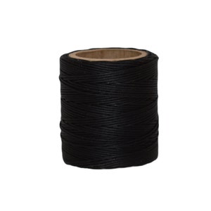 May include: A spool of black waxed thread.