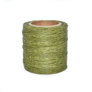 May include: A spool of green waxed linen thread.