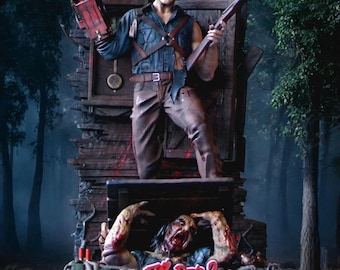 May include: A detailed, hand-painted statue of Ash Williams from the Evil Dead franchise. Ash is holding a chainsaw in one hand and a shotgun in the other. He is standing on a wooden platform with a zombie figure underneath. The statue is set against a dark forest background. The base of the statue features the text "Evil Dead 2: Dead By Dawn."