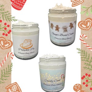 May include: Three jars of whipped body butter with festive labels. Flavours include Pumpkin Pie, Gingerbread Cookie, and Candy Cane. Each jar is 113 g / 227 g. The image has a Christmas theme with gingerbread men, candy canes, and a mug.
