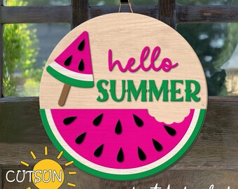 May include: A wooden door hanger with a watermelon design. The watermelon is pink and green with black seeds. The text "hello summer" is written in green letters on the hanger.