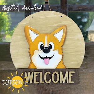 May include: A wooden welcome sign with a cartoon corgi dog peeking over the top. The sign is painted brown and has the word "WELCOME" in white letters. The corgi is orange and white with a pink tongue sticking out.