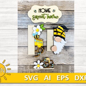 May include: Wooden sign with the text "Home Sweet Home" in a white banner with yellow flowers and bees. A gnome with a black and yellow bee hat and a beehive with a bee are also included.