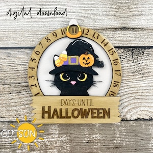 May include: A wooden Halloween countdown clock with a black cat wearing a witch's hat and holding a pumpkin. The clock has numbers 1 through 19 around the edge. The text "DAYS UNTIL HALLOWEEN" is written on a banner below the clock.