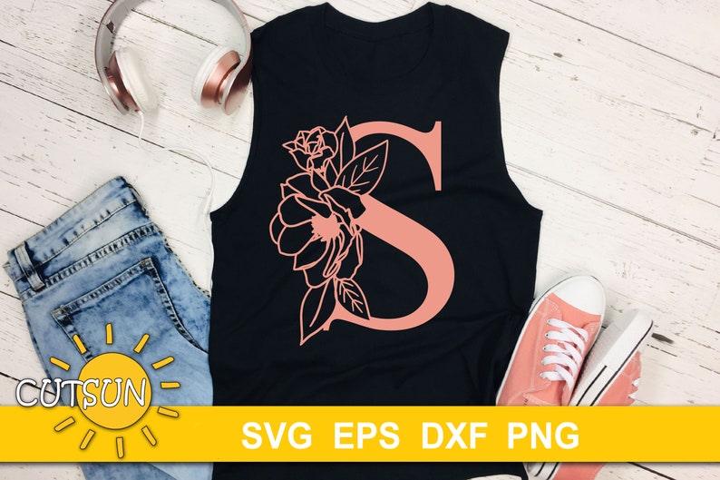 May include: A black tank top with a pink floral design and the letter "S" in the center. The text "SVG EPS DXF PNG" is printed at the bottom of the image.