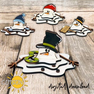 May include: Wooden snowman decorations with a melting snow effect. Each snowman wears a different hat, including a top hat, a blue hat, and a red hat. One snowman has a sign that says "Thomas". The image also includes the text "CUTSUN" and "Digital download".