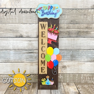 May include: A wooden welcome sign with the word "WELCOME" spelled vertically. The sign is decorated with a pink cake with strawberries and candles, colorful balloons, a birthday hat, and a gift box. The sign also has a blue banner with the text "HAPPY BIRTHDAY" on it.