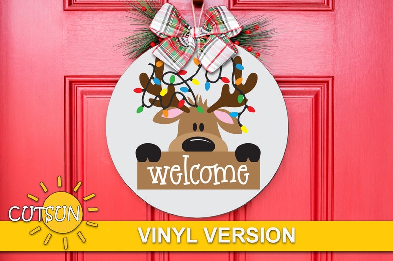 May include: A white round wooden door hanger featuring a reindeer with a string of Christmas lights and holding a sign that says "welcome".