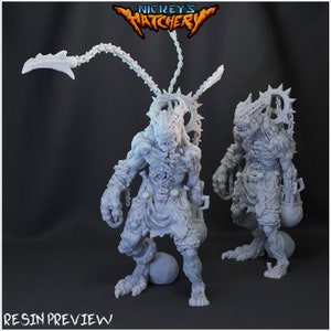 May include: Two gray resin miniatures of monstrous creatures with chains and spikes. The creature on the left has a long chain with a hook attached to its head. The creature on the right has a chain with a bucket attached to its leg. The text "Nickey's Hatchery" is visible at the top of the image.