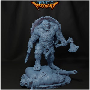 May include: A grey, detailed miniature of a turtle-like creature with a large axe in its right hand. The creature is standing on a smaller grey miniature of a defeated creature.