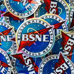 May include: A close-up of several holographic stickers with the text "Billionaire Should Not Exist" and "BSNE" in a blue, red, and white color scheme. The stickers feature a rocket ship design with stars and a galaxy background.