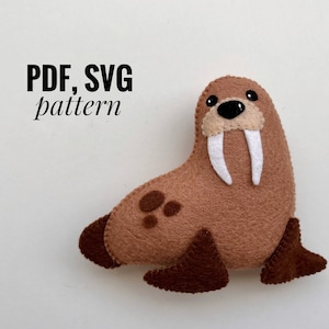 May include: PDF and SVG pattern for a brown felt walrus plush toy with white tusks and black eyes. The toy has brown felt flippers.