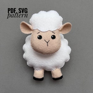 May include: A handcrafted felt sheep toy with a white, fluffy body and head, a tan face and ears, and black eyes. The sheep has black hooves. The image includes the text "PDF, SVG pattern".