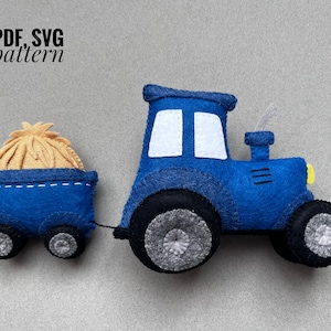May include: Blue felt toy tractor with a bale of hay in the trailer. The tractor has white windows and a grey wheel. PDF, SVG pattern.