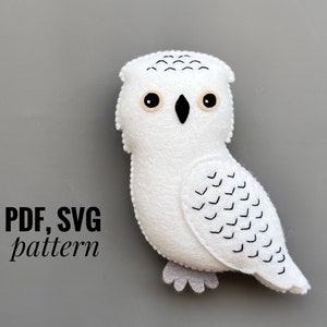 May include: A white felt owl with black eyes and a black beak. The owl has a black and white patterned wing. The text "PDF, SVG pattern" is in the lower left corner of the image.