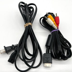 May include: A black power cord with a US plug, a black AV cable with a yellow, white, and red RCA connector, and a black cable with a connector labeled "SONY".