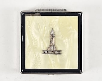 Powder compact souvenir Empire State Building NYC motif on celluloid lid; mirror, sponge and sifter insert; vintage mid century accessory