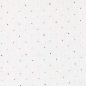 May include: White fabric with a repeating pattern of small, colorful crosses. The crosses are in shades of red, yellow, teal, gray, and orange, scattered across the white background. The fabric appears to be cotton or a similar material.