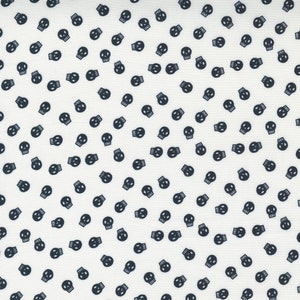 May include: White fabric with a repeating pattern of small black skull silhouettes.