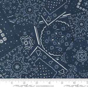 May include: A navy blue fabric with a white bandana pattern. The fabric is made up of a patchwork of different bandana designs.