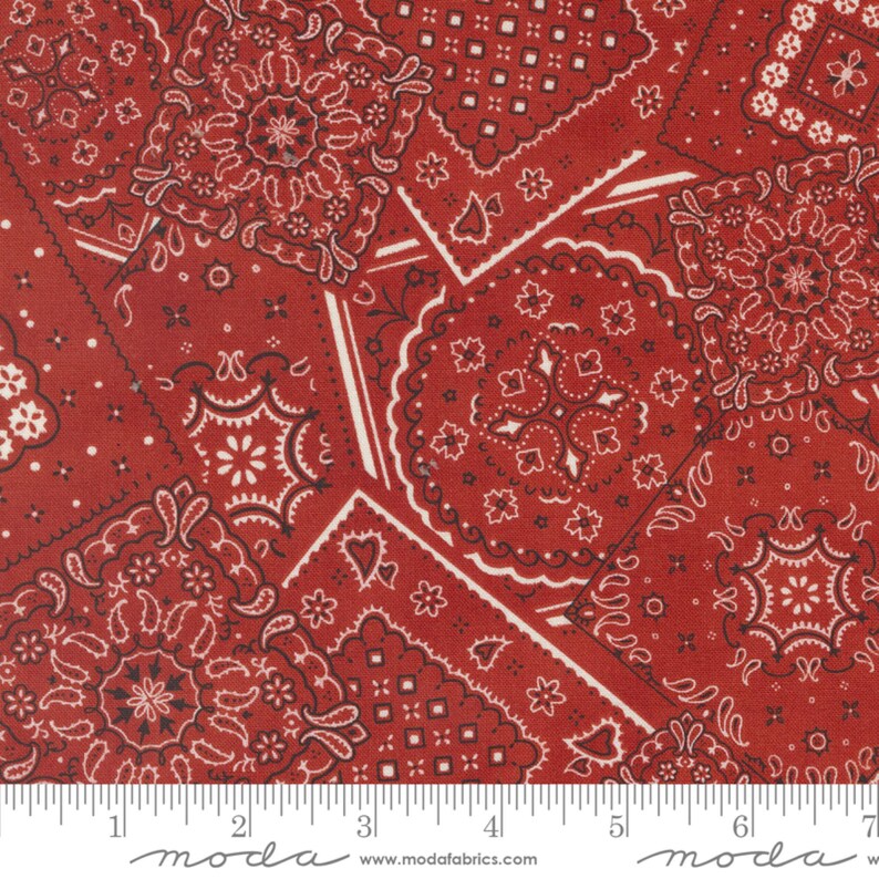 May include: Red fabric with a repeating pattern of white and black bandana designs. The fabric is a patchwork of different bandana patterns.