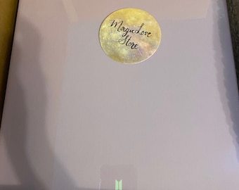 May include: A purple box with the text "WINTER PACKAGE 2021" and a sticker that says "Magic Love Store". The box has a small, green, stylized butterfly logo on the bottom.