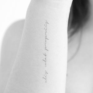 May include: A close-up of a person's arm with a tattoo that reads "this is what i  propose".