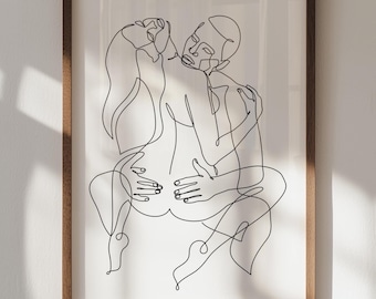 May include: A framed art print featuring a minimalist line drawing of two figures embracing. The artwork is rendered in black lines on a white background, encased in a wooden frame. The figures are intertwined in a close embrace.