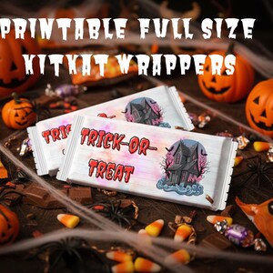 May include: Printable full-size KitKat wrappers with "Trick or Treat" text and a haunted house graphic. The image features orange pumpkins, candy corn, and spider decorations, creating a Halloween theme.
