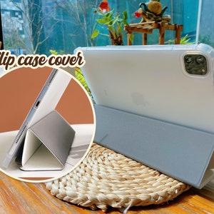 May include: A light blue tablet case with a clear back and a flip cover. The case is folded to create a stand for the tablet. The text "Flip case cover" is visible in the image.