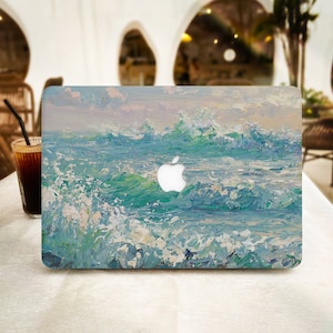 May include: A laptop skin featuring a painted design of blue ocean waves crashing against each other. The skin has a white Apple logo cutout.