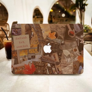 May include: A laptop with a collage of images on the cover. The images include a building, a book, a coffee cup, and a leaf. The text "don't wish for it, work for it" is visible on the cover.