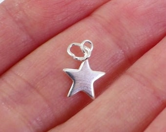 May include: A silver star charm with a jump ring for attaching to jewelry or other crafts.