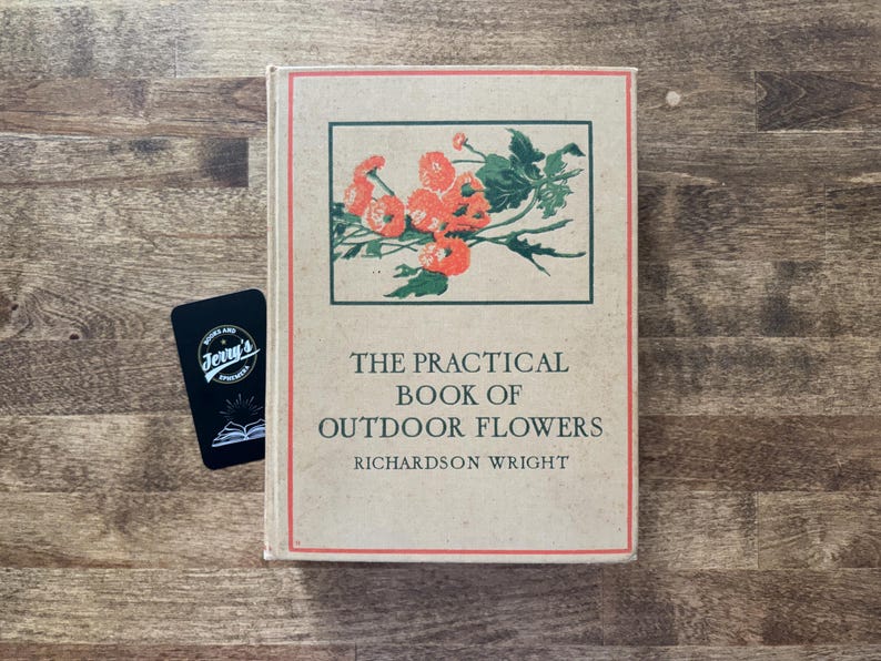 May include: A hardcover book titled The Practical Book of Outdoor Flowers by Richardson Wright, featuring a tan cover with a red border and a central illustration of orange flowers with green leaves, accompanied by a small black rectangular card.