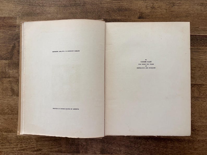 May include: An open hardcover book with off-white pages. The left page displays copyright text from 1934 and printing information. The right page features a dedication to Cond&eacute; Nast for years of inspiration and guidance in black serif font.